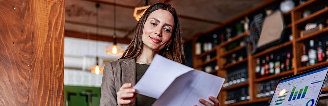 Business owner reviewing documents for year-end tax planning.